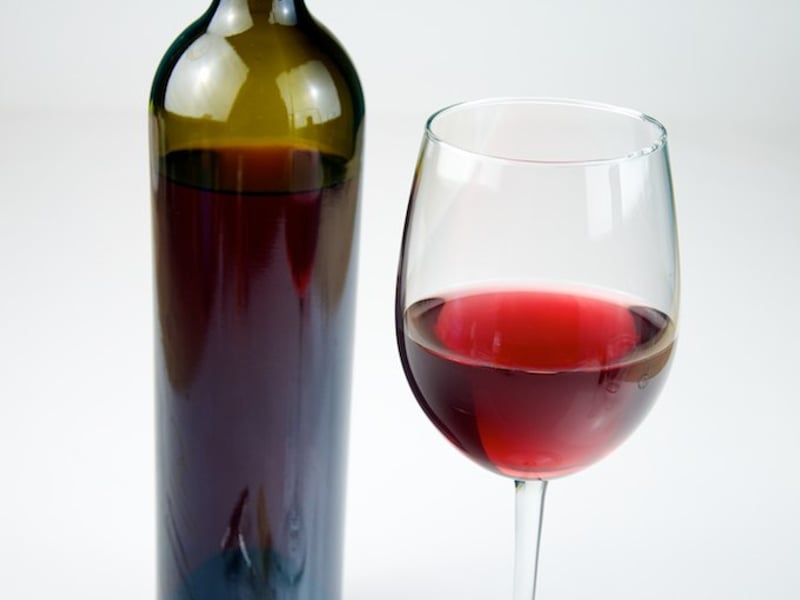 Vintage red wine bottle and wine goblet